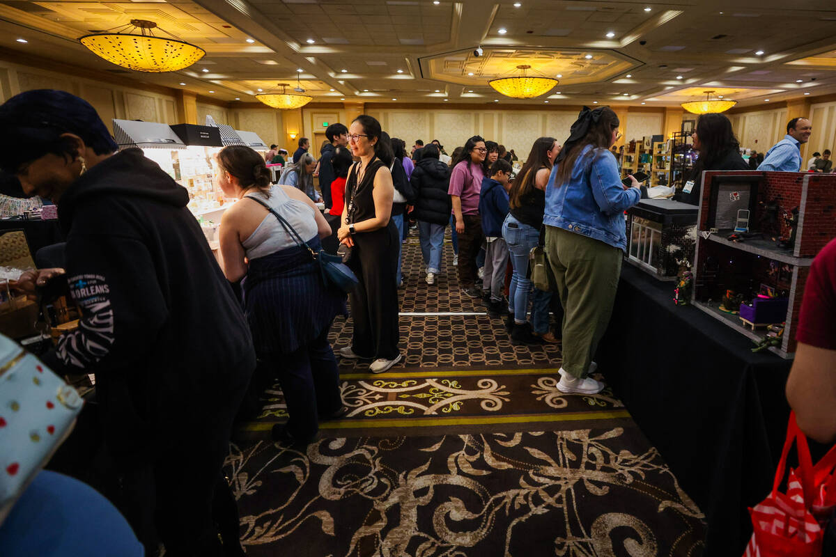 Attendees browse miniature item displays during the fourth annual International Market of Minia ...