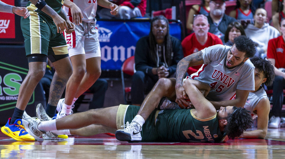 UNLV forward Jeremiah Cherry (45) battles on the court for a loose ball with Colorado State Ram ...