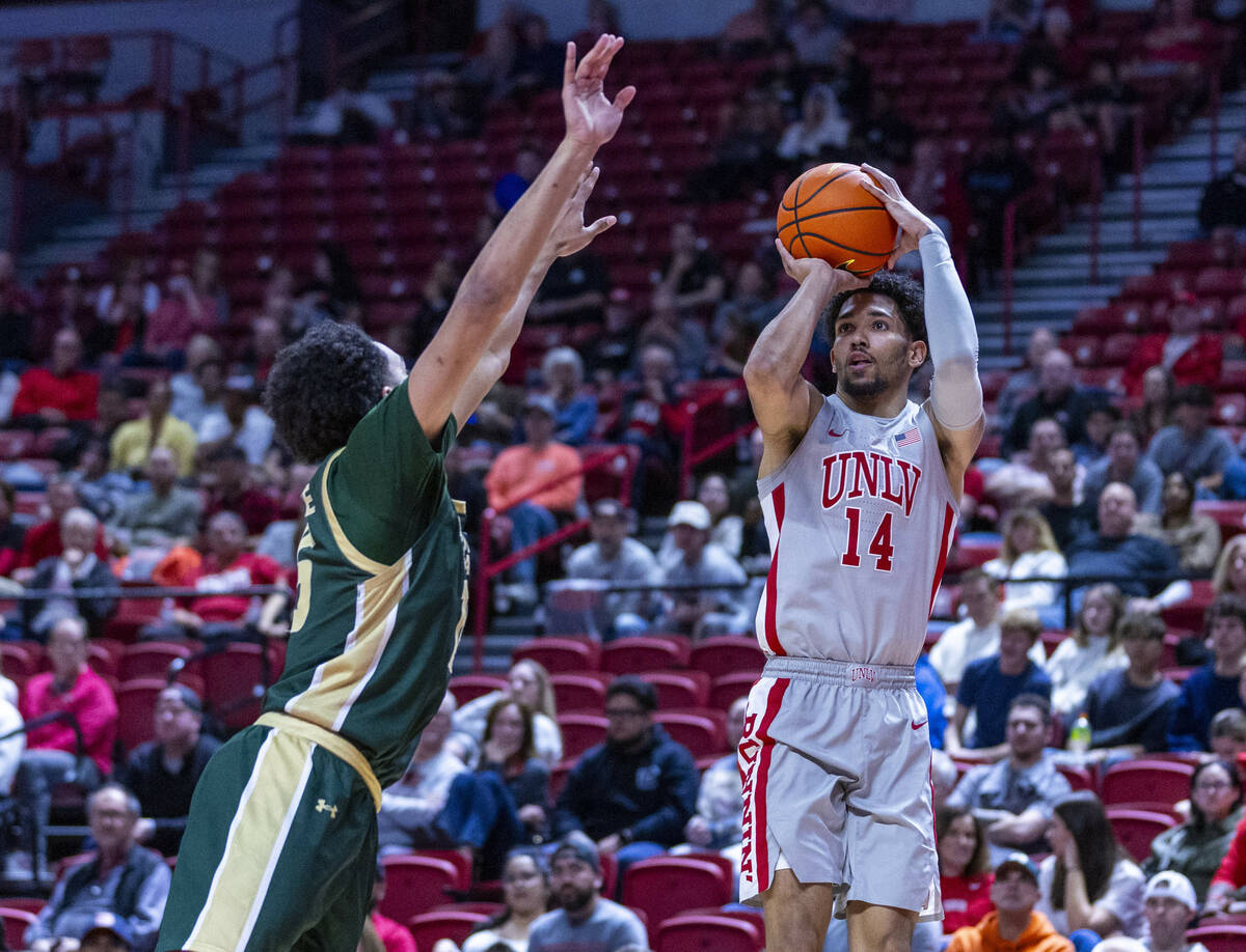 UNLV guard Jailen Bedford (14) lines ups a shot over Colorado State Rams guard Jalen Lake (15) ...
