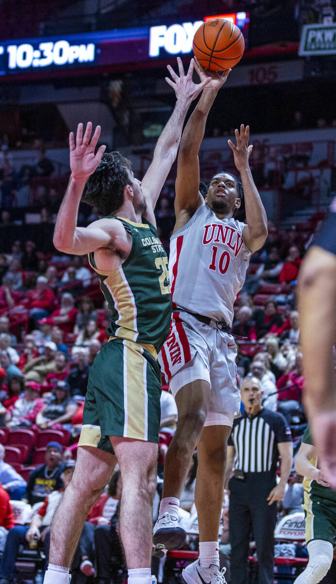UNLV guard Jaden Henley (10) posts up for a shot just over Colorado State Rams guard Ethan Mort ...