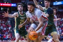UNLV forward Jeremiah Cherry (45) looks for an opening to shoot while double teamed by Colorado ...