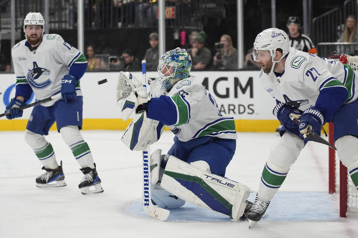 Vancouver Canucks goaltender Kevin Lankinen (32) makes a glove save against the Vegas Golden Kn ...