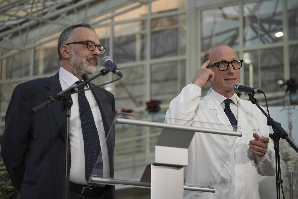 Surgeon Sergio Alfieri, right, and Pope Francis personal doctor Luigi Carboni speak to journali ...