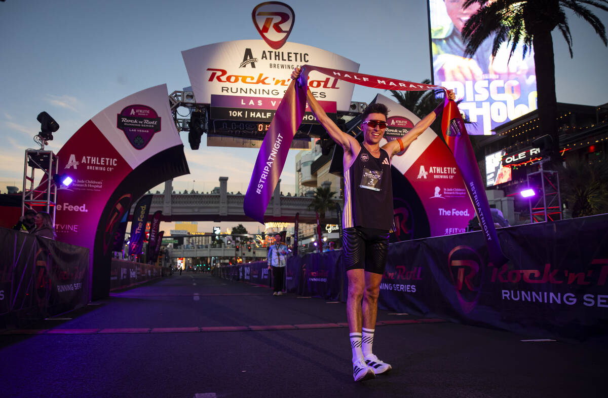 Johannes Motschmann, of Germany, celebrates after placing first in the men’s half-marath ...