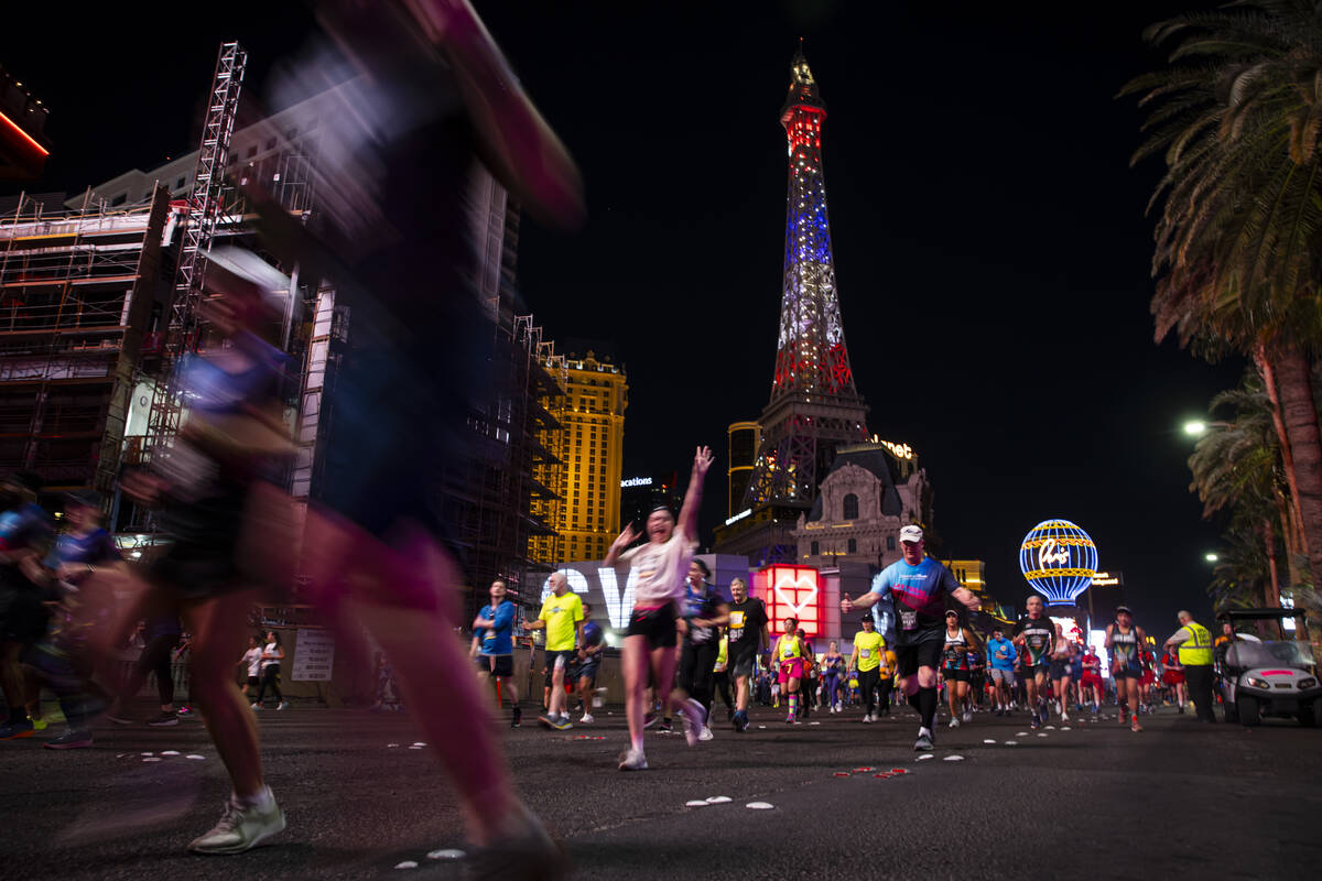 Participants compete in the 10k and half-marathon along the Las Vegas Strip during the Rock &#x ...