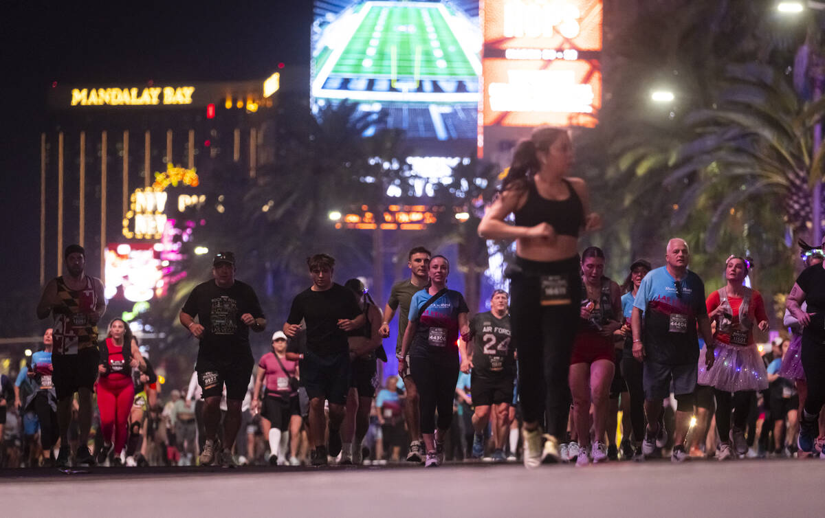 Participants compete in the 10k and half-marathon along the Las Vegas Strip during the Rock &#x ...