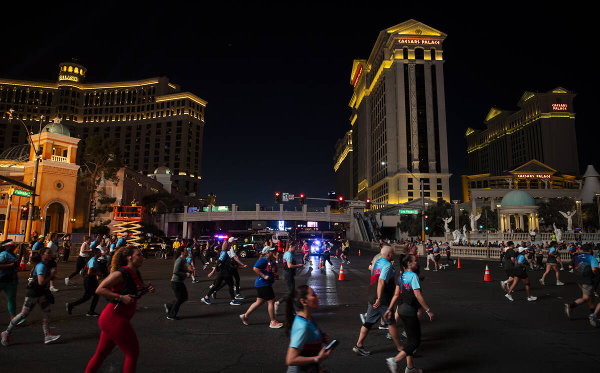 Participants compete in the 10k and half-marathon along the Las Vegas Strip during the Rock &#x ...