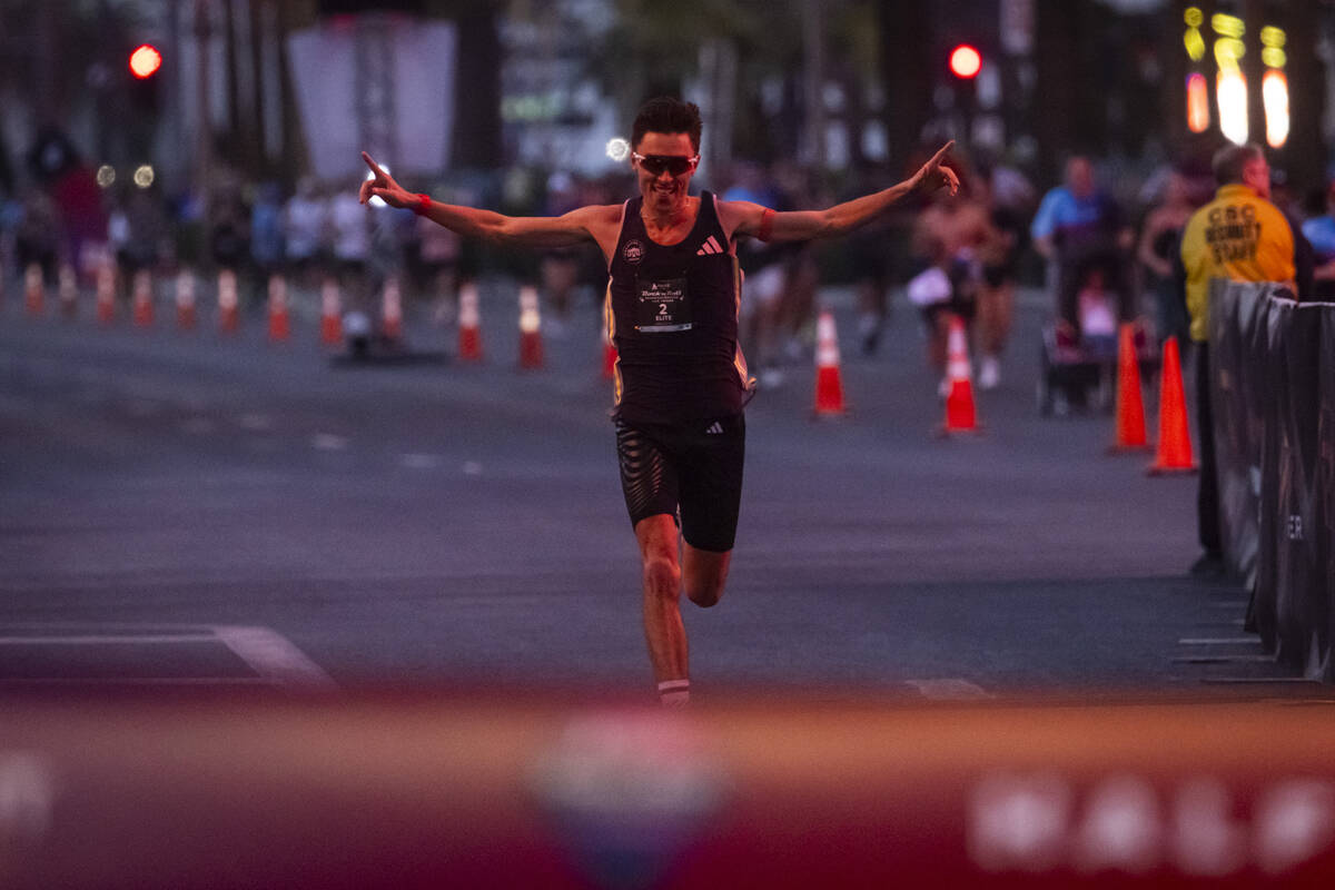 Johannes Motschmann, of Germany, celebrates while approaching the finish line to place first in ...