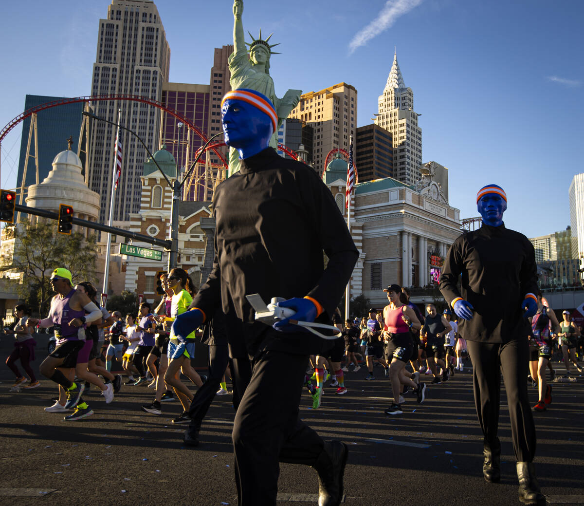 Members of the Blue Man Group interact with race participants as they take off from the start l ...