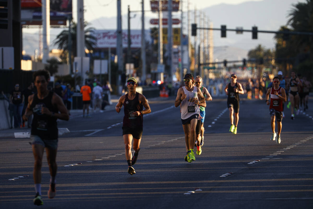 Participants compete in the 10k and half-marathon along the Las Vegas Strip during the Rock &#x ...
