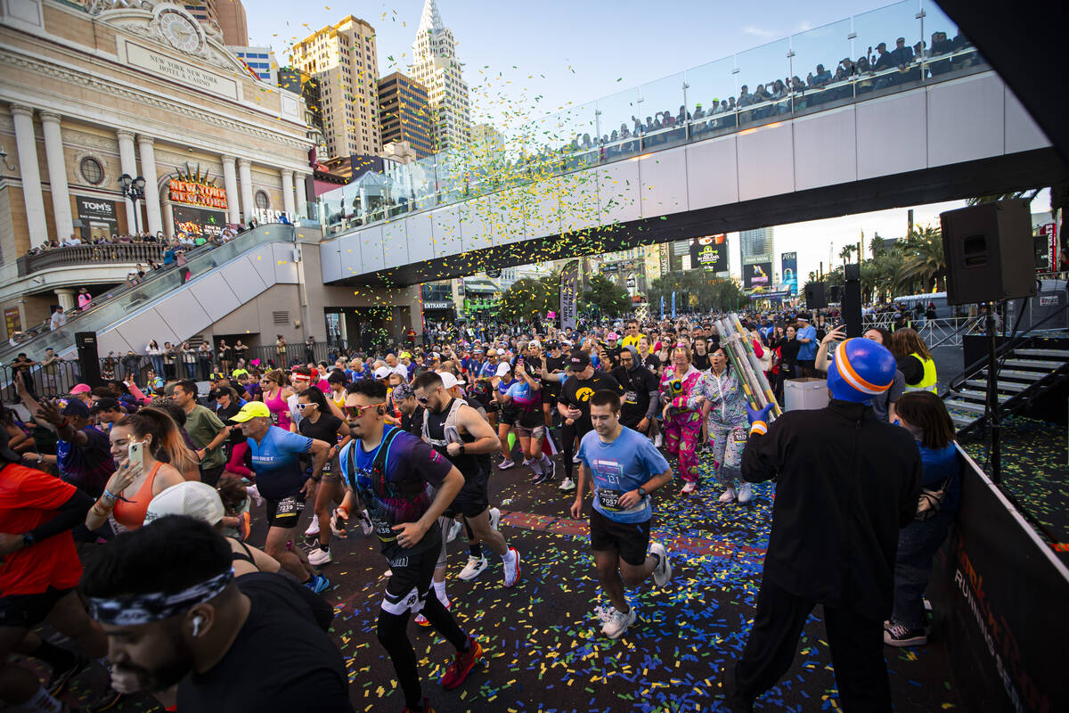 Members of the Blue Man Group interact with race participants as they take off from the start l ...