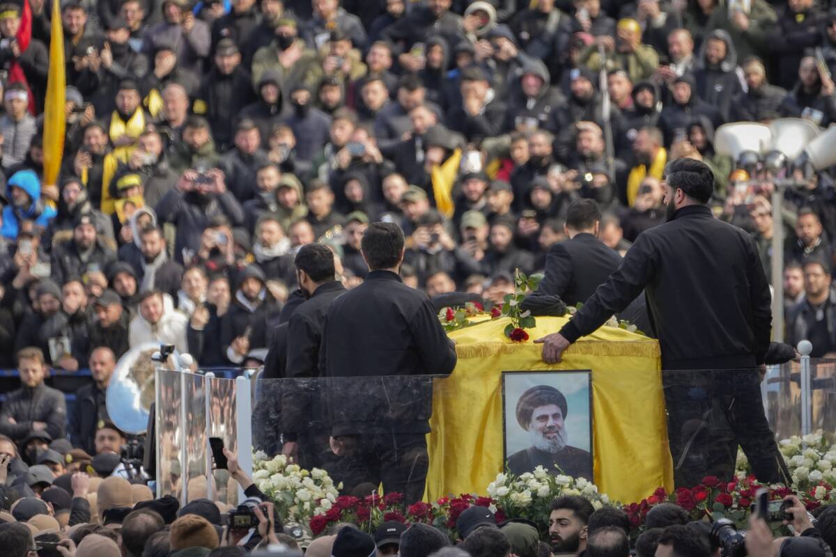 A trailer carrying the coffins containing the bodies of Hezbollah's former leader Hassan Nasral ...