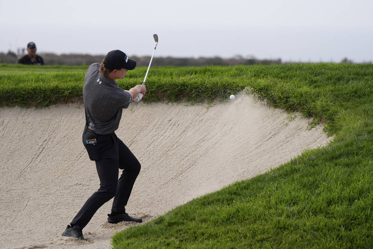 Maverick McNealy hits out of a bunker on the 14th hole of the South Course at Torrey Pines duri ...