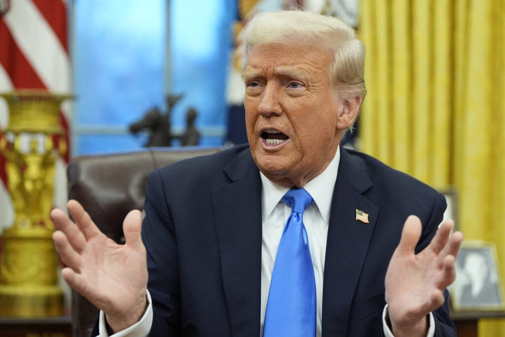 President Donald Trump speaks with reporters in the Oval Office at the White House, Tuesday, Fe ...