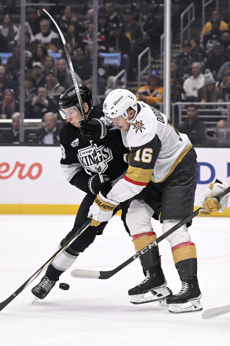 Los Angeles Kings defenseman Jacob Moverare, left, and Vegas Golden Knights left wing Pavel Dor ...
