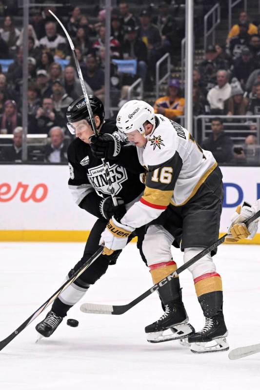 Los Angeles Kings defenseman Jacob Moverare, left, and Vegas Golden Knights left wing Pavel Dor ...