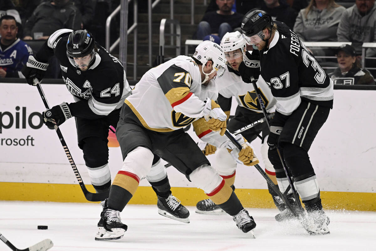 Los Angeles Kings center Phillip Danault (24) takes the puck away from Vegas Golden Knights lef ...