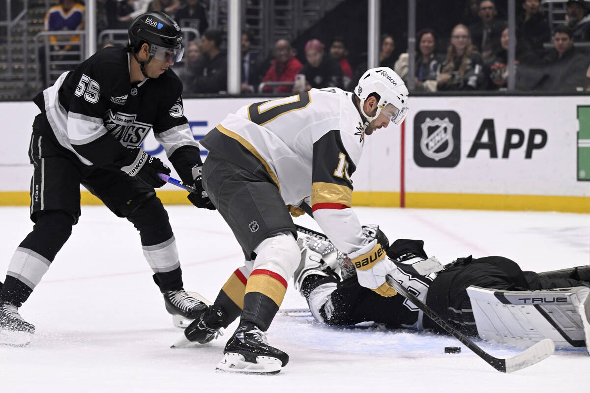Los Angeles Kings goaltender Darcy Kuemper, bottom right, stops a shot by Vegas Golden Knights ...