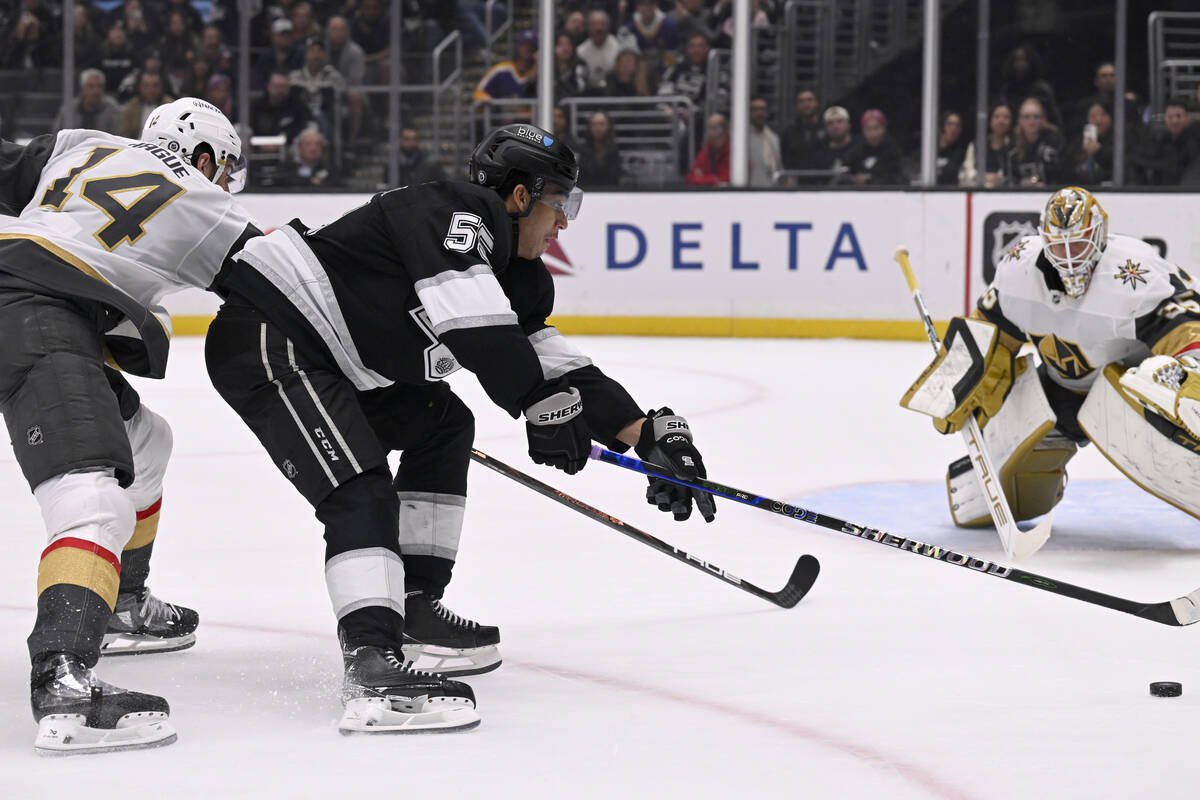 Los Angeles Kings right wing Quinton Byfield (55) reaches for the puck with Vegas Golden Knight ...