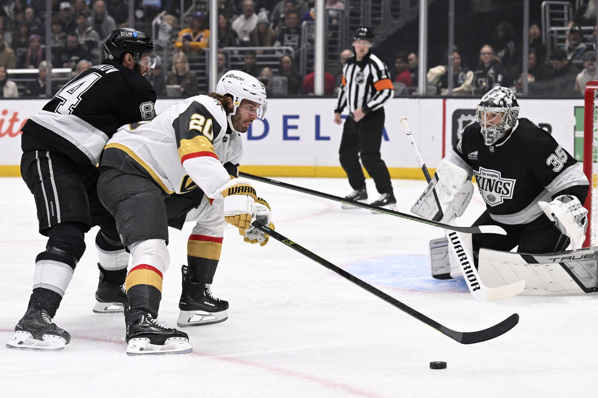 Vegas Golden Knights left wing Brandon Saad (20) controls the puck with pressure from Los Angel ...