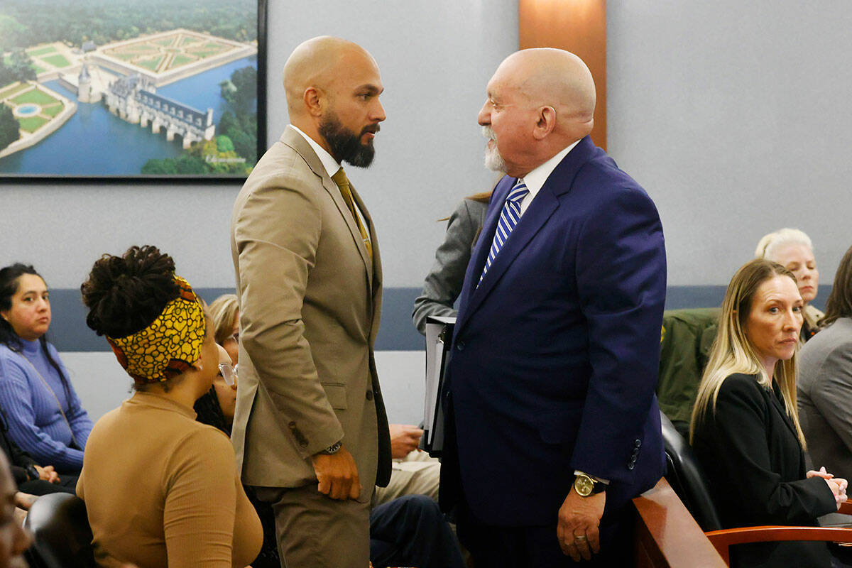 Metropolitan Police Department Sgt. Kevin Menon, left, talks with his attorney Dominic Gentile ...