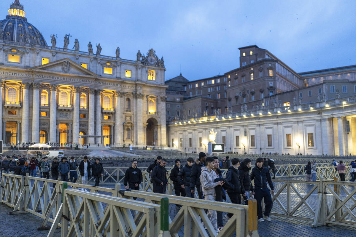 People walk in St. Peter's square at The Vatican, Monday, Feb. 24, 2025. (AP Photo/Mosa'ab Elshamy)