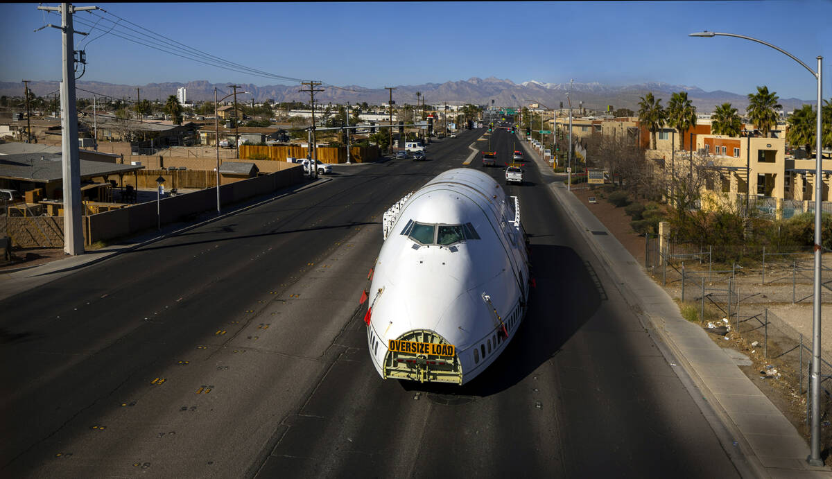 A decommissioned 747 fuselage section is transported along East Cheyenne Avenue to the expanded ...
