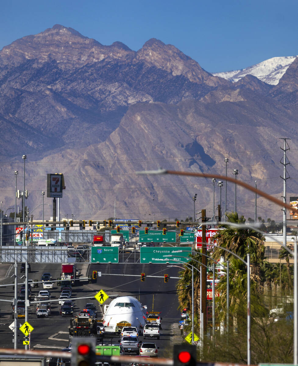 A decommissioned 747 fuselage section is transported along East Cheyenne Avenue to the expanded ...