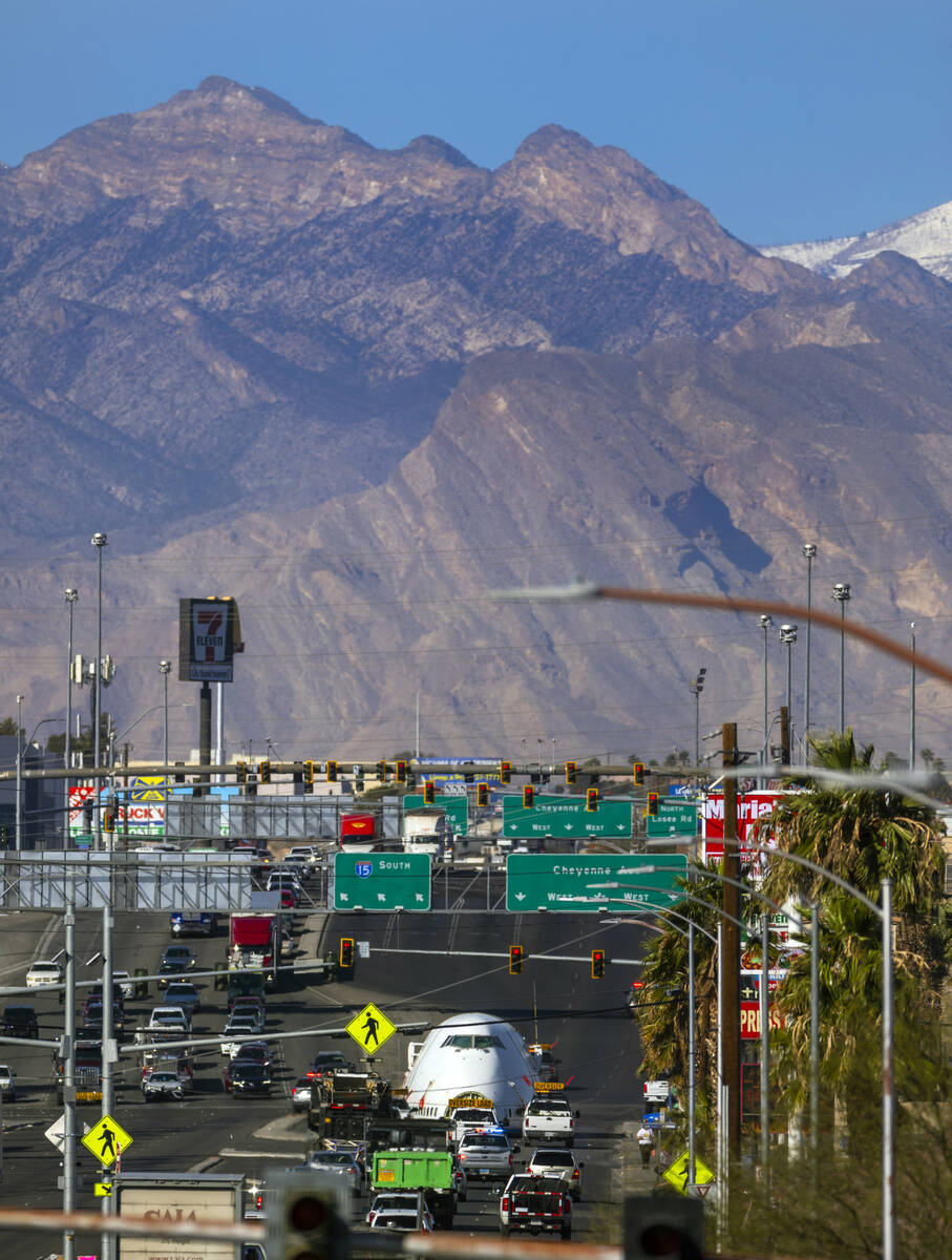 A decommissioned 747 fuselage section is transported along East Cheyenne Avenue to the expanded ...