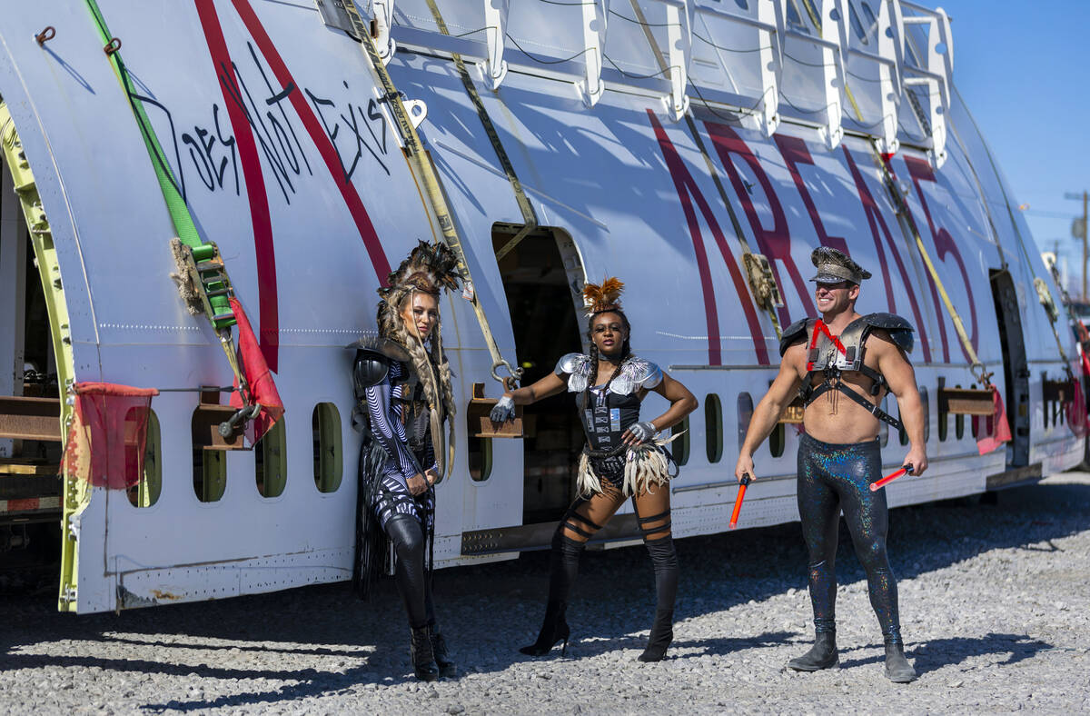 Area15 models Kasey Perlinger, Nichet ray and Zach Derr stand about a decommissioned 747 fusela ...