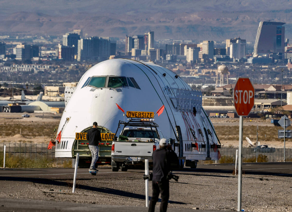 A decommissioned 747 fuselage is escorted as it departs from the Las Vegas Speedway on North La ...
