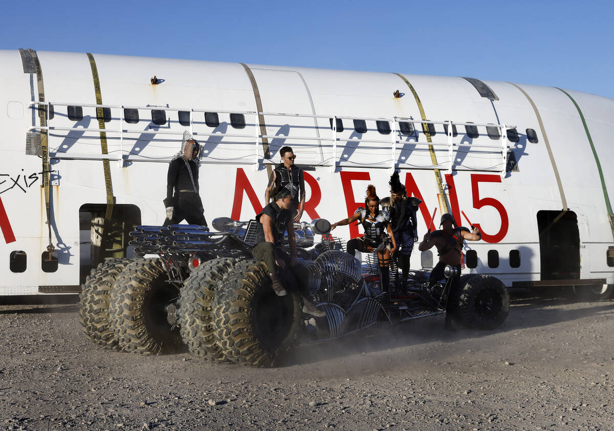 Area15 models pose for a photo on a Henry Chang art car in front of a decommissioned 747 fusela ...