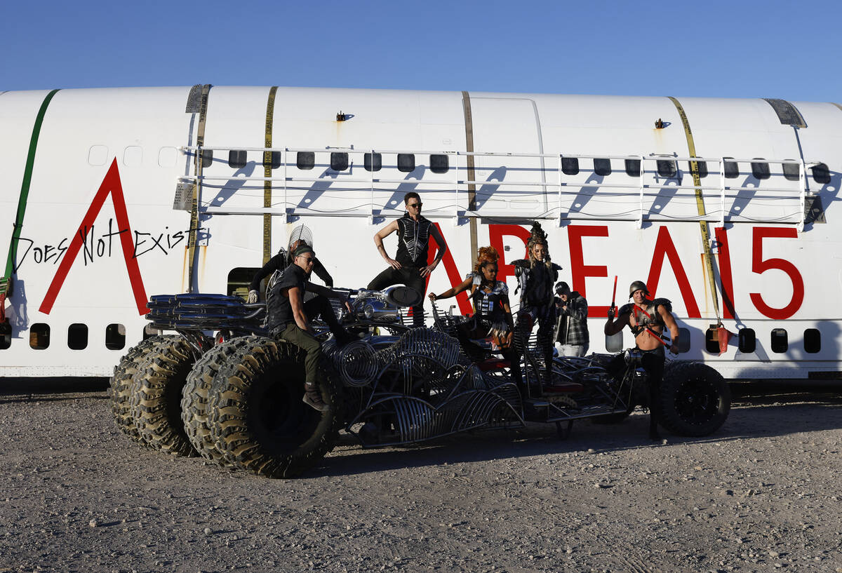 Area15 models pose on a Henry Chang art car for a photo in front of a decommissioned 747 fusela ...
