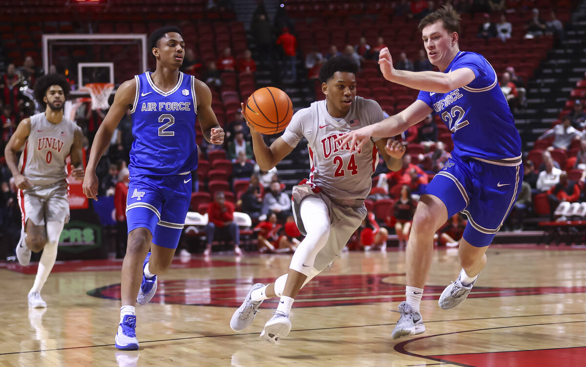 UNLV guard DeMarion Yap (24) drives to the basket against Air Force forward Sam Springer (22) d ...