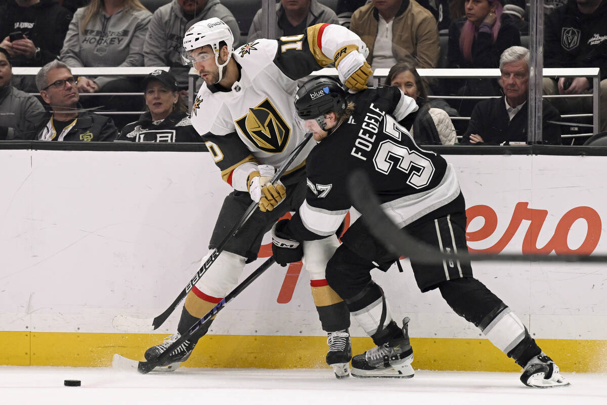 Los Angeles Kings left wing Warren Foegele (37) takes the puck away from Vegas Golden Knights c ...