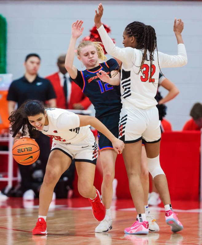 Lady Rebels guard Teagan Colvin (0) avoids Boise State Broncos guard Mary Kay Naro (12) as she ...