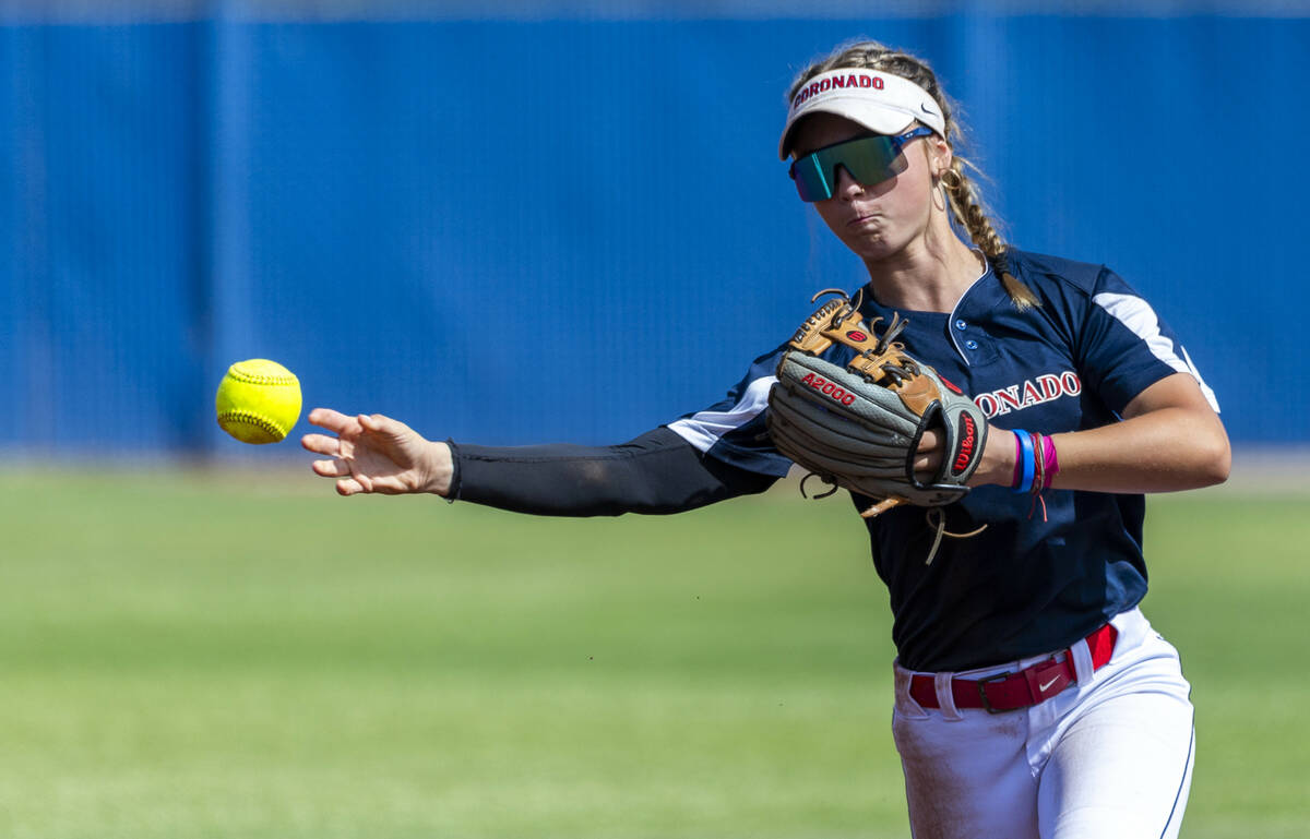 Coronado infielder Bailey Goldberg (1) throws to first base against a Douglas runner during the ...