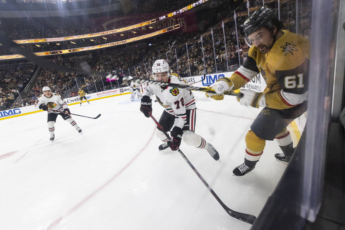 Golden Knights right wing Mark Stone (61) and Chicago Blackhawks defenseman TJ Brodie (78) vie ...