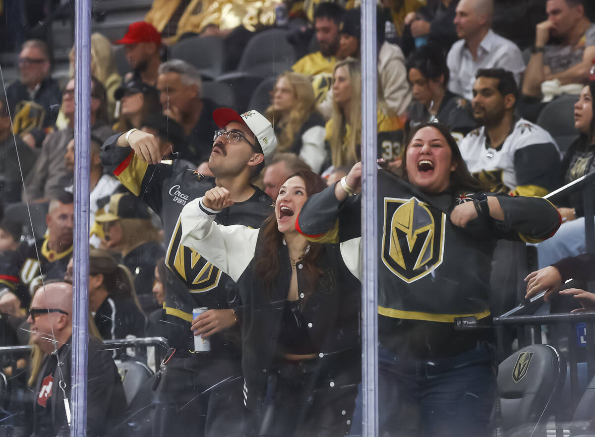 Golden Knights fans cheer during the third period of an NHL hockey game against the Chicago Bla ...