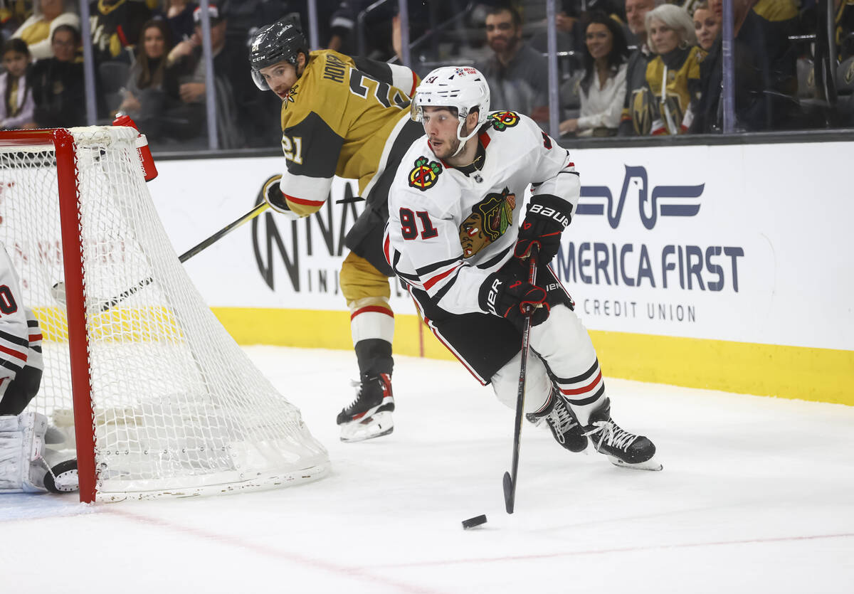 Chicago Blackhawks center Frank Nazar (91) skates with the puck as Golden Knights center Brett ...