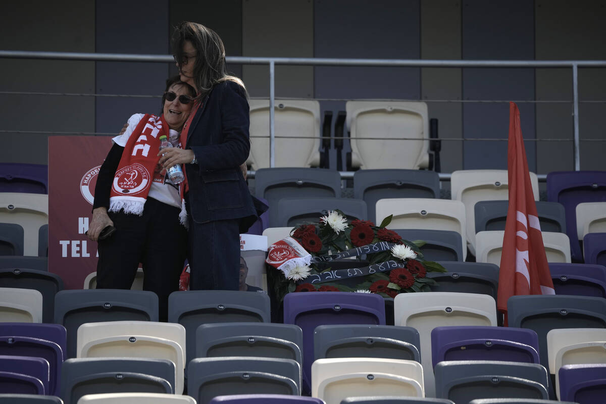 Dvora Idan, left, is comforted at a public memorial ceremony for her son, slain hostage Tsachi ...