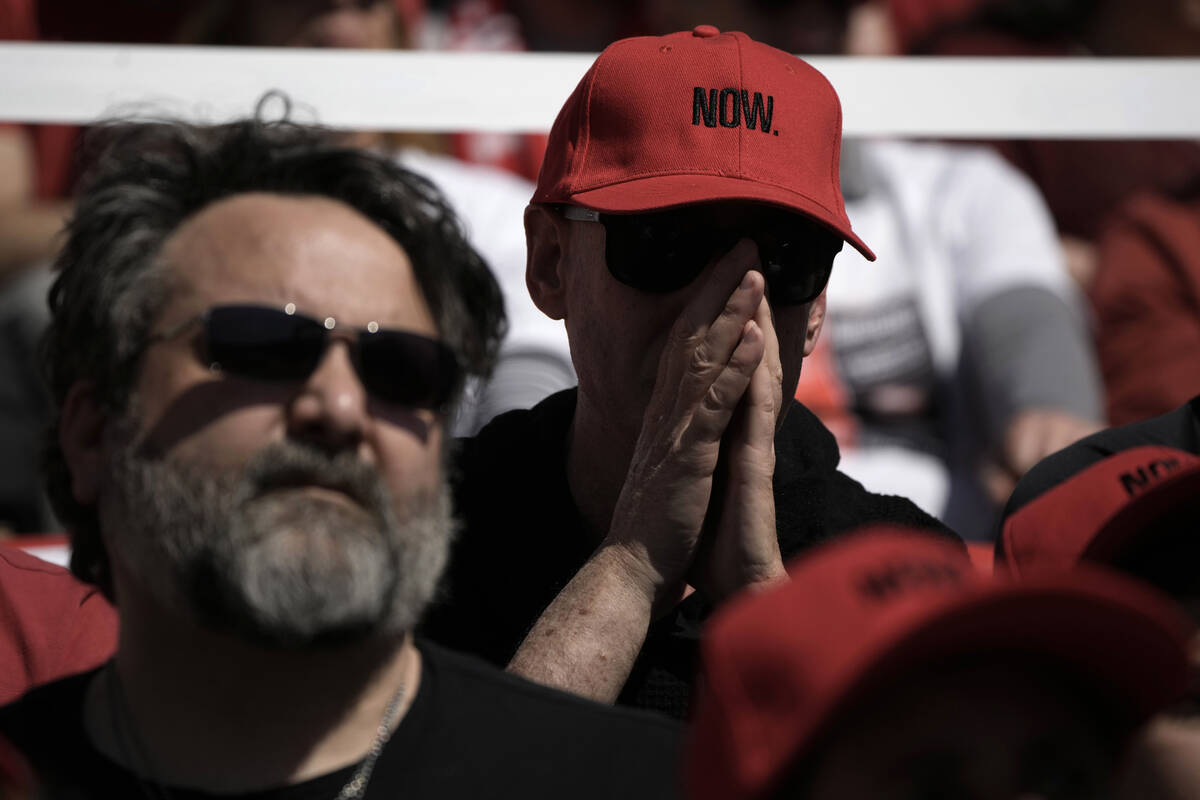 People attend a public memorial ceremony for slain hostage Tsachi Idan, a fan of Hapoel Tel Avi ...