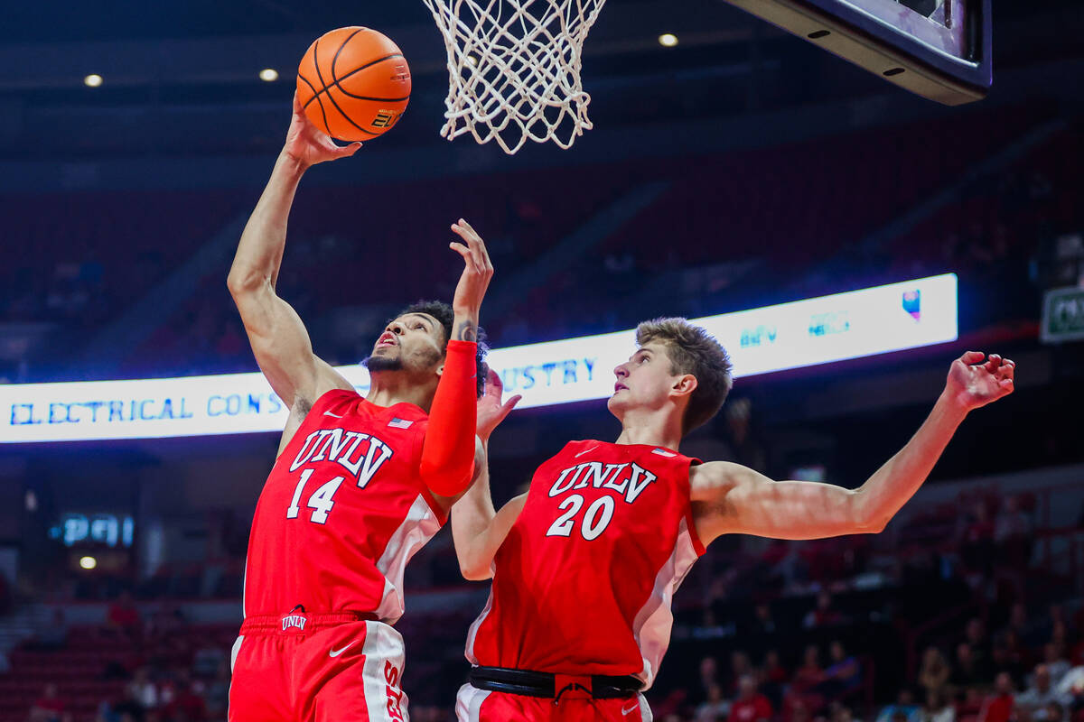 Rebels guard Jailen Bedford (14) grabs the ball from an attempted shot by the UNR Wolf Pack dur ...