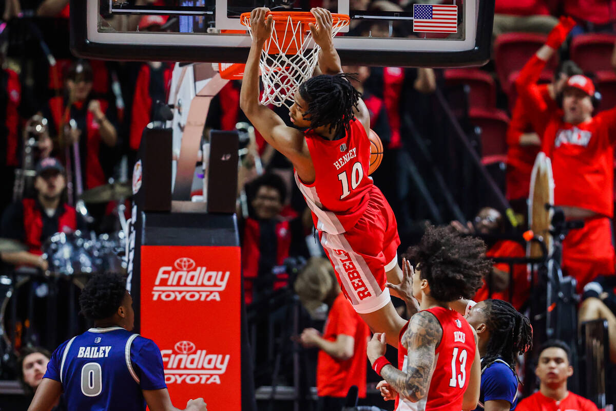 Rebels guard Jaden Henley (10) dunks the ball during an NCAA men’s basketball game betwe ...
