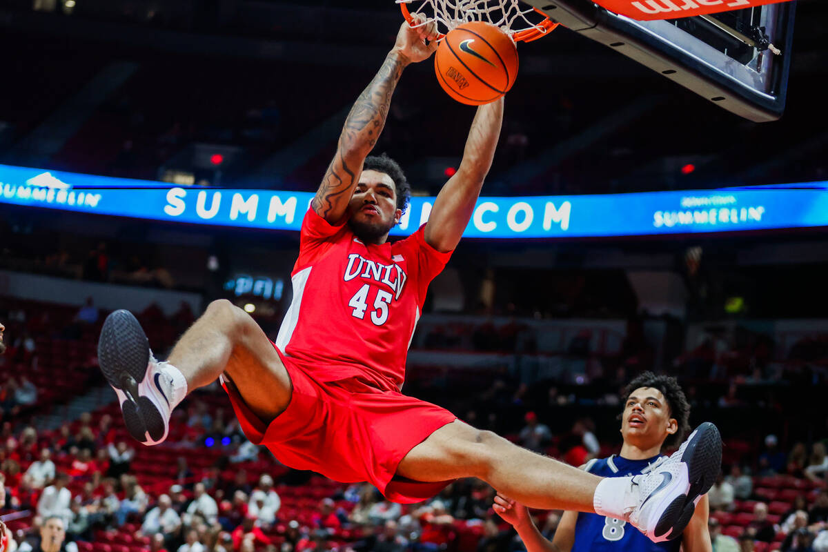 Rebels forward Jeremiah Cherry (45) goes up for a slam dunk during an NCAA men’s basketb ...
