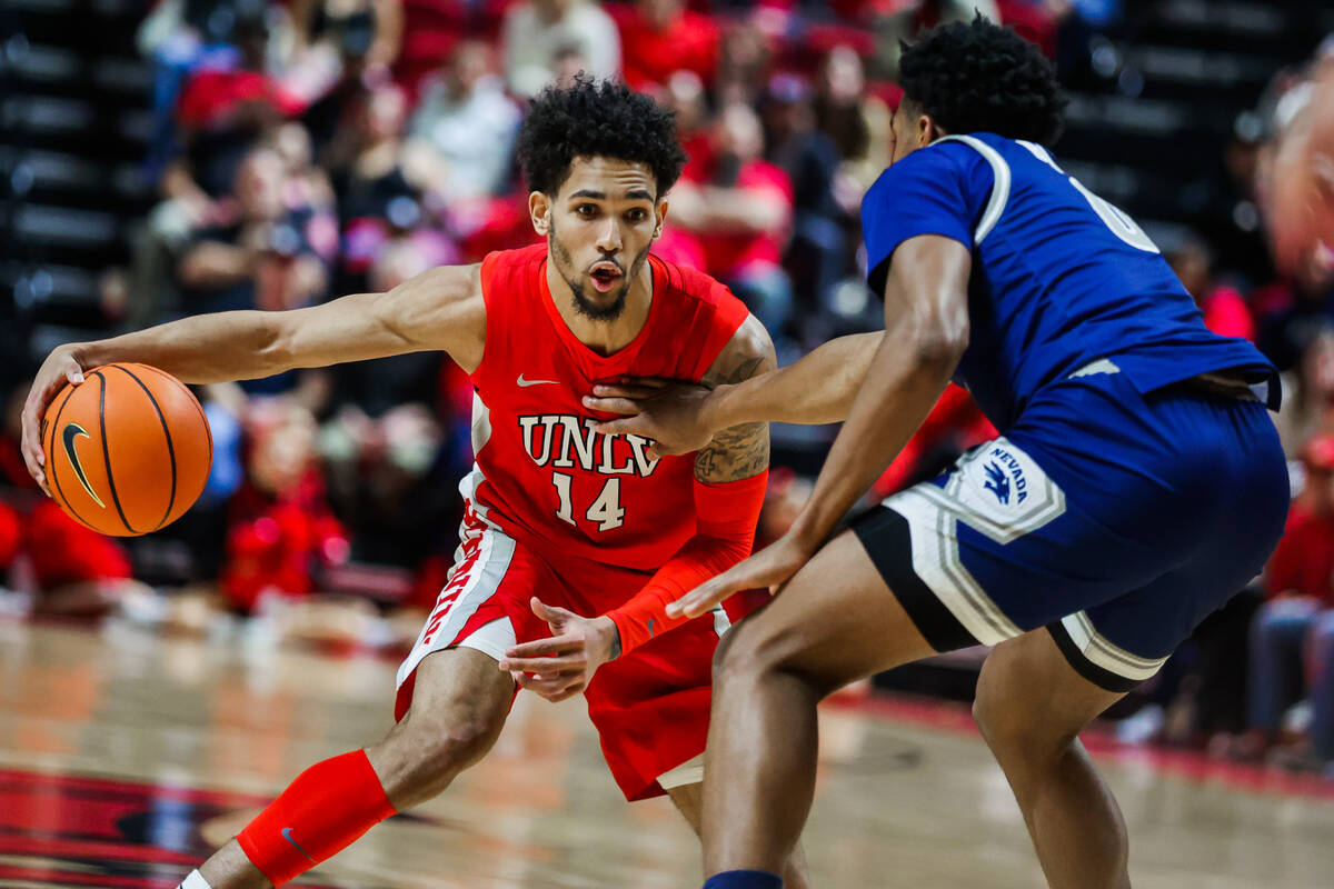 Rebels guard Jailen Bedford (14) dribbles the ball during an NCAA men’s basketball game ...