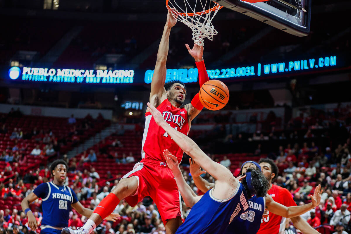 Rebels guard Jailen Bedford (14) attempts a dunk during an NCAA men’s basketball game be ...