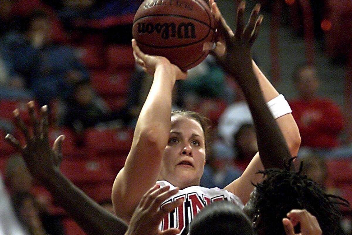 UNLV senior forward Linda Frohlich (13) shoots through traffic as she goes over the heads of Sa ...