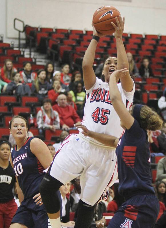 Kelli Thompson, (45) of the UNLV Lady Rebels scores two of her team high 25 points while being ...