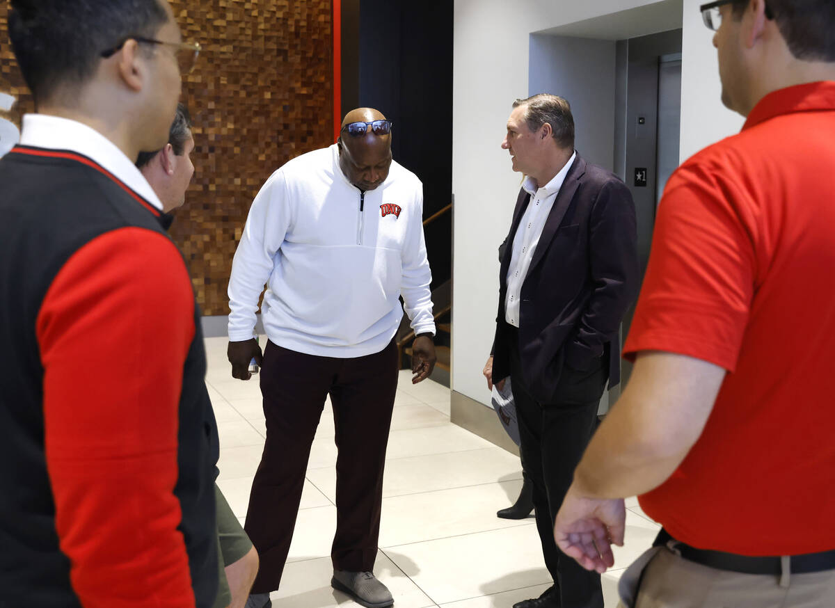 UNLV athletic director Erick Harper, left, chats with football head coach Dan Mullen at Fertitt ...